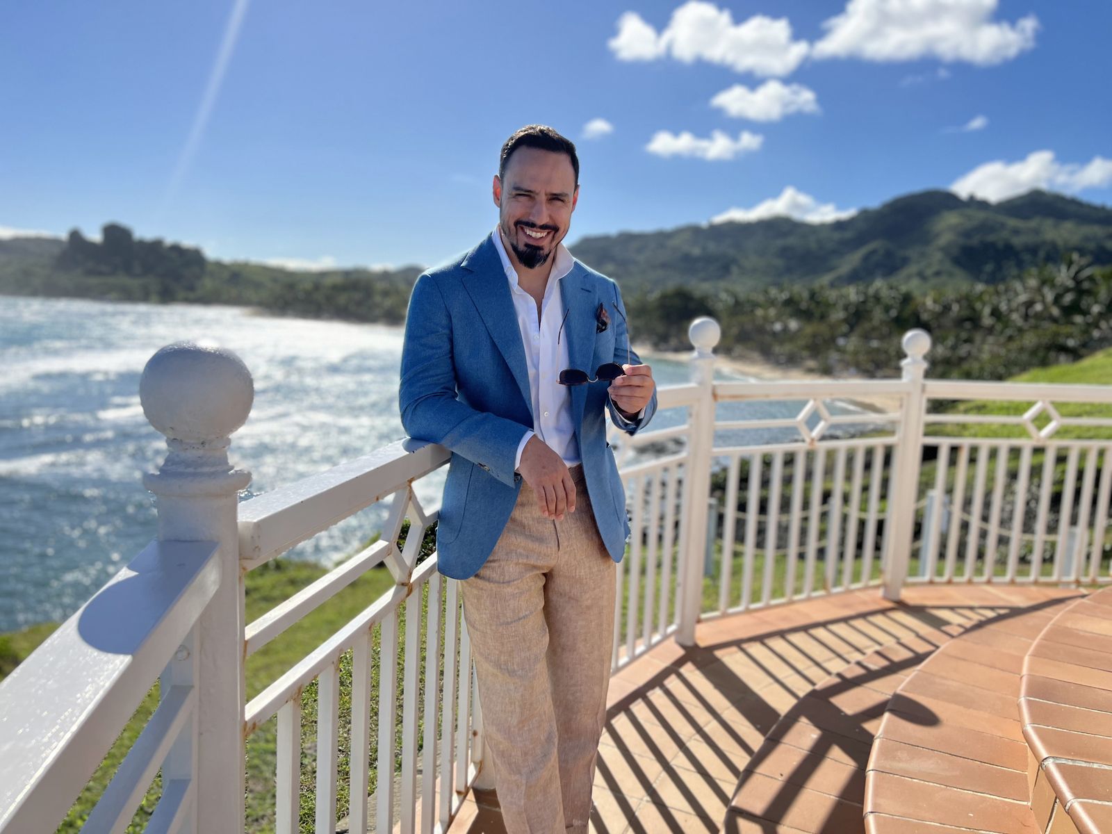 Light blue blazer with tan trousers by the sea