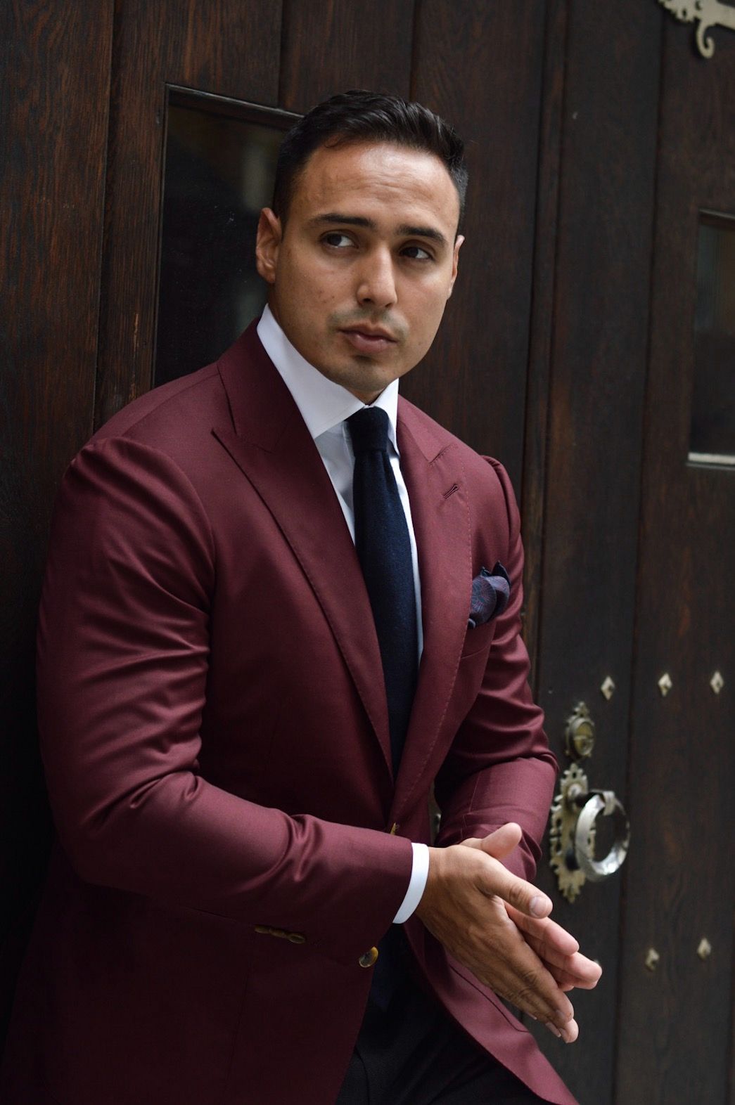 Burgundy suit with a navy tie